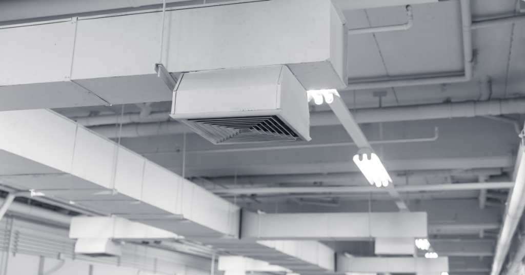 Image of a North Bay Heating and Cooling worker performing a repair in a home.
